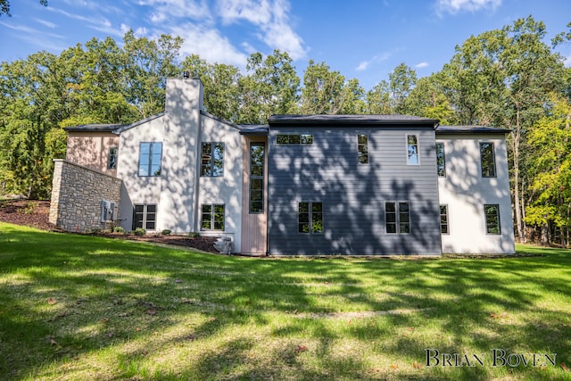 rear view of property with a yard