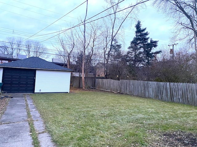 view of yard featuring a garage and an outdoor structure