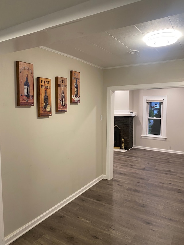 corridor with crown molding and dark wood-type flooring