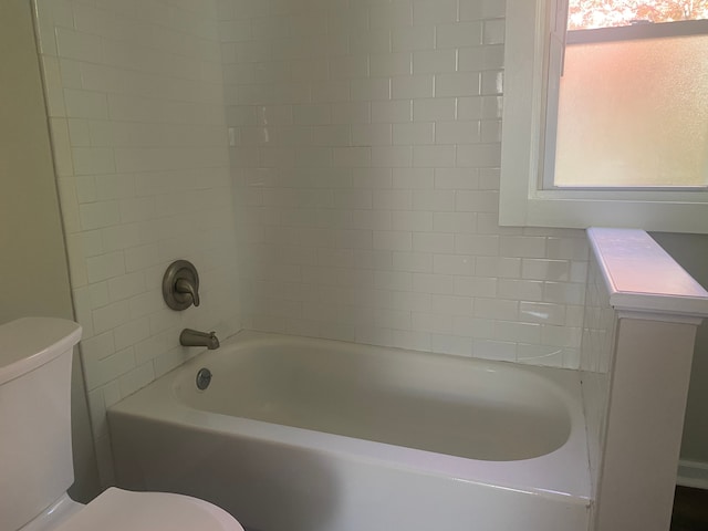 bathroom featuring shower / bath combination and toilet