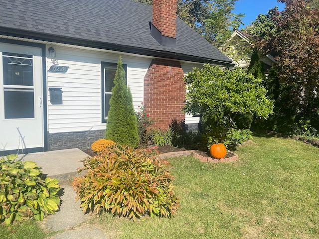 view of side of home with a lawn