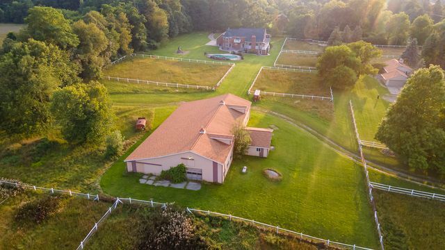 birds eye view of property with a rural view