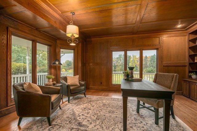 home office with wood walls, wooden ceiling, and light hardwood / wood-style flooring