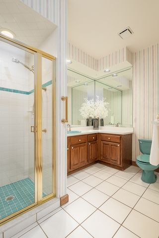 bathroom with vanity, toilet, and an enclosed shower