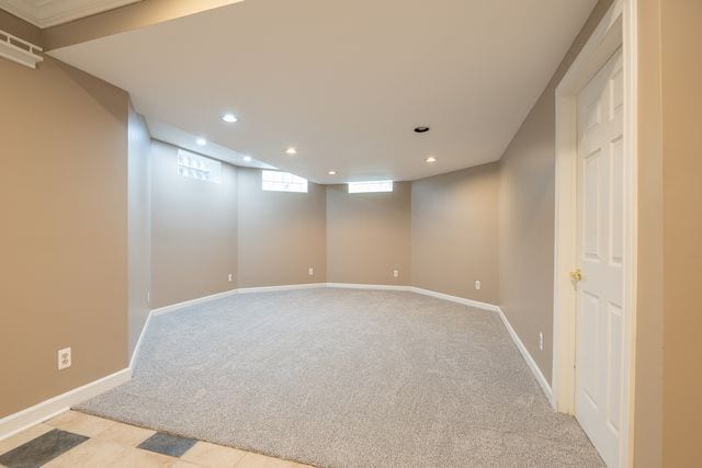 basement featuring light colored carpet