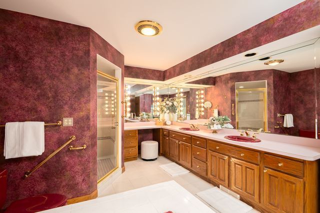 bathroom with tile patterned flooring, vanity, and walk in shower