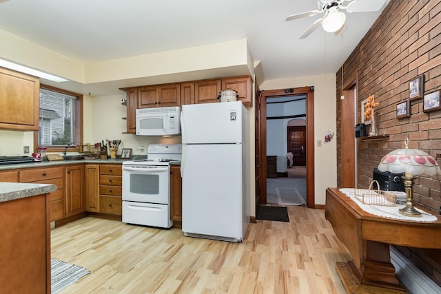 kitchen with white appliances, light hardwood / wood-style floors, ceiling fan, and brick wall