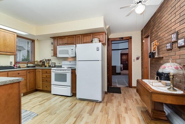 207 N Pine River St, Ithaca, MI 48847 - kitchen featuring white appliances, light wood-style flooring, brown cabinets, a ceiling fan, and brick wall