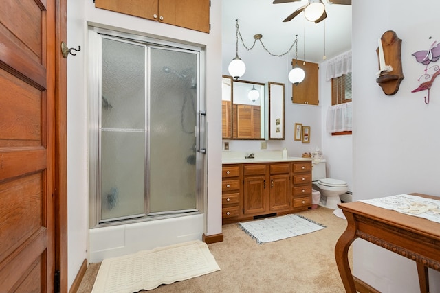 full bathroom featuring ceiling fan, toilet, vanity, and combined bath / shower with glass door