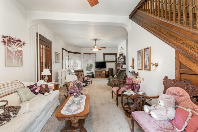 207 N Pine River St, Ithaca, MI 48847 - carpeted living room with a ceiling fan and arched walkways