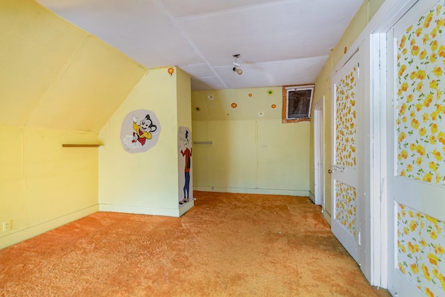 interior space featuring carpet flooring and lofted ceiling