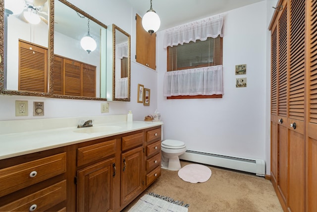 bathroom featuring vanity, ceiling fan, toilet, and a baseboard radiator