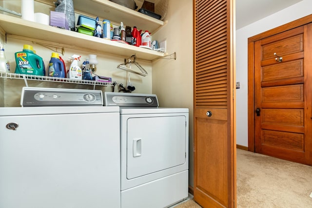 laundry room with light colored carpet and separate washer and dryer