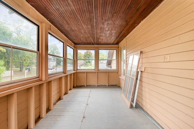 unfurnished sunroom with wood ceiling