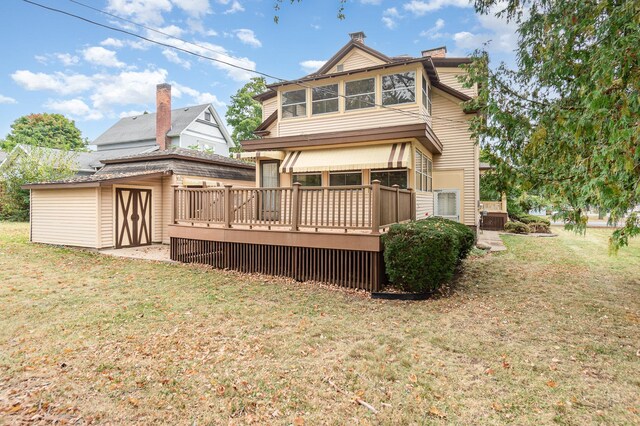 207 N Pine River St, Ithaca, MI 48847 - rear view of house featuring a deck, a yard, and a chimney