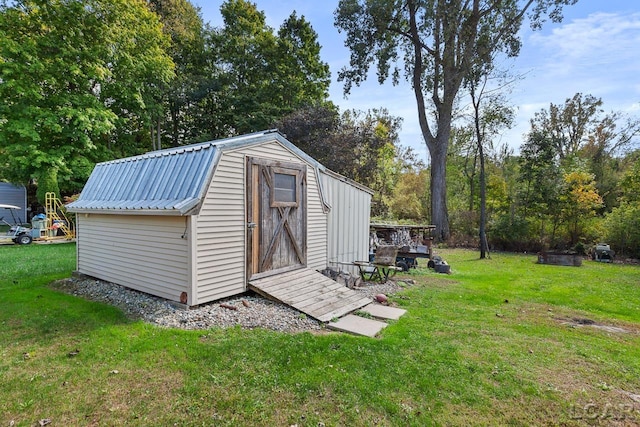 view of outbuilding with a lawn