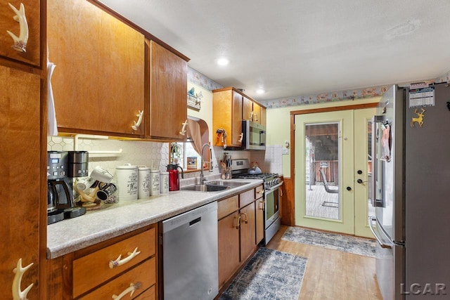 kitchen with sink, light wood-type flooring, and stainless steel appliances