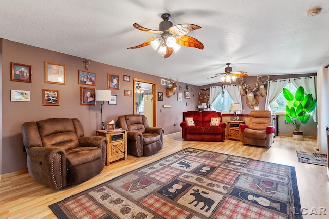 living room featuring wood-type flooring and a textured ceiling