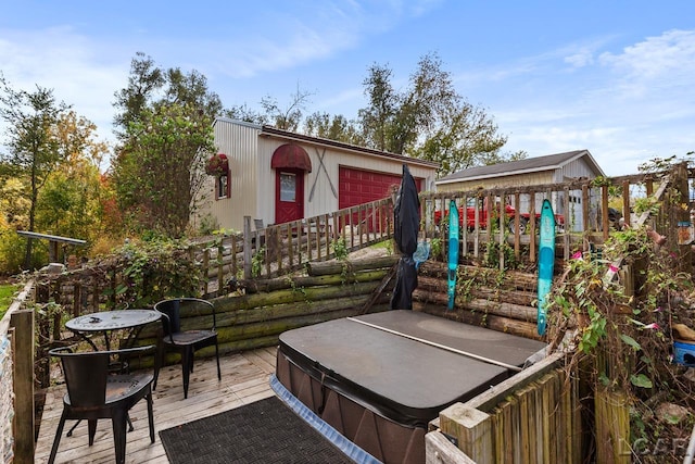 exterior space with a covered hot tub and a wooden deck