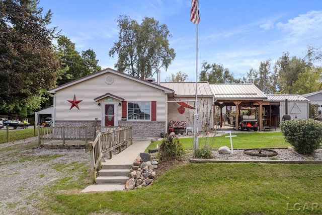 view of front of property with an outbuilding and a front lawn