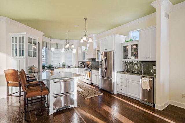 kitchen with visible vents, glass insert cabinets, dark wood finished floors, stainless steel appliances, and a warming drawer