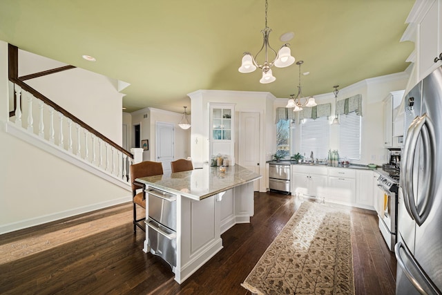 kitchen with dark wood finished floors, appliances with stainless steel finishes, white cabinetry, and a warming drawer