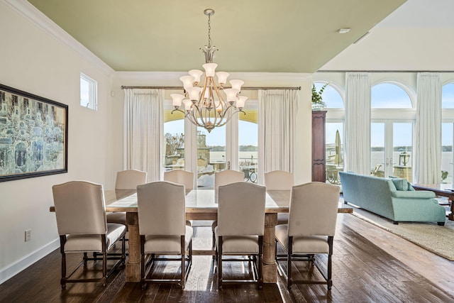 dining space featuring baseboards, an inviting chandelier, dark wood-style flooring, french doors, and crown molding