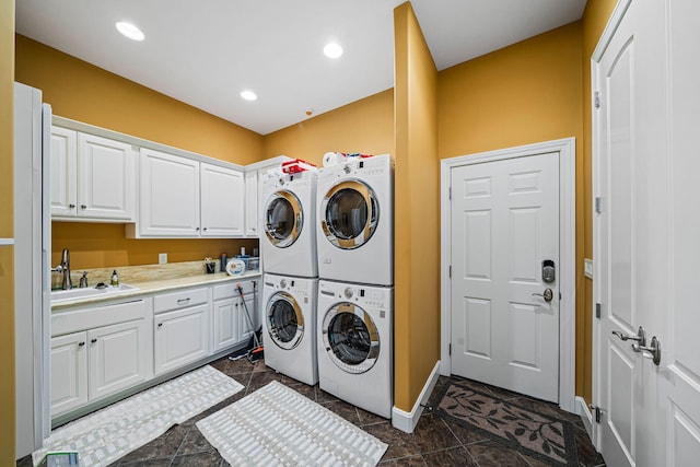 laundry room featuring a sink, recessed lighting, cabinet space, stacked washer / drying machine, and separate washer and dryer