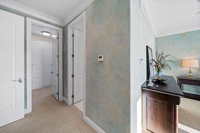 hall with light colored carpet, baseboards, and ornamental molding