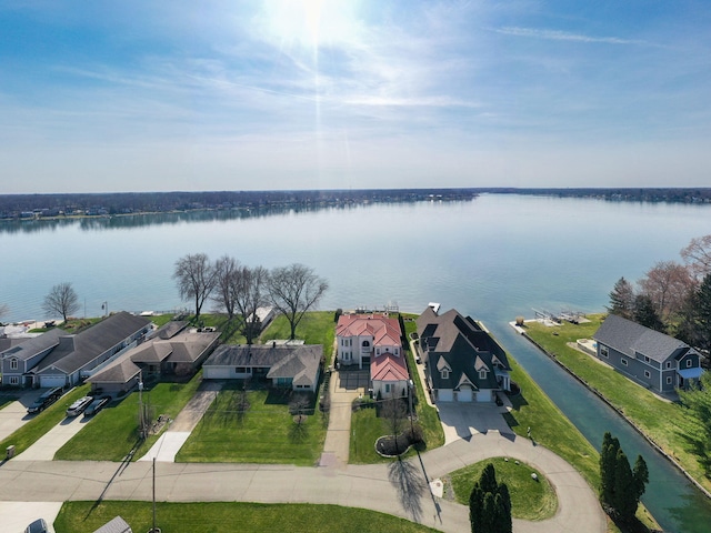 birds eye view of property with a residential view and a water view