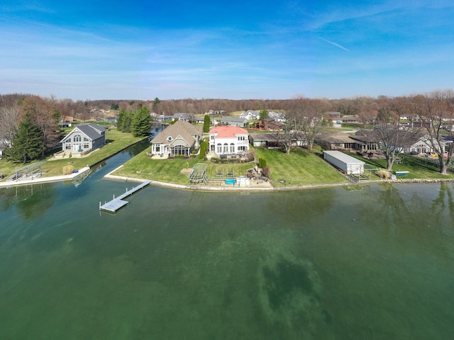 birds eye view of property with a water view and a residential view