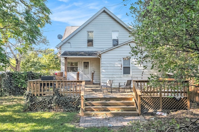 back of property featuring a wooden deck