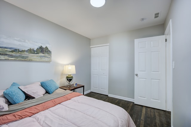 bedroom featuring dark hardwood / wood-style flooring and a closet