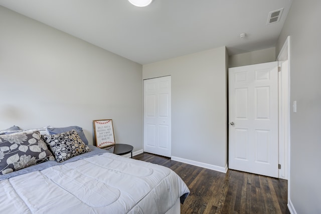 bedroom featuring dark hardwood / wood-style floors and a closet