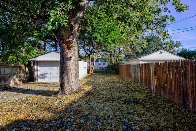 view of yard featuring an outbuilding and a garage