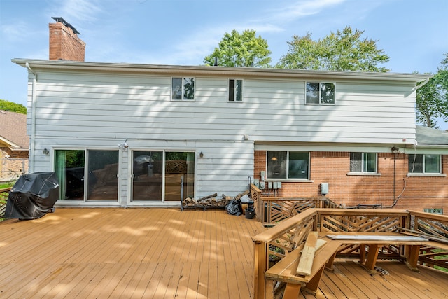 rear view of property with a wooden deck