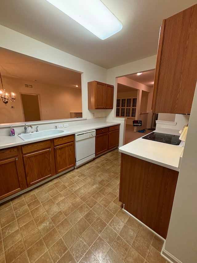 kitchen with white dishwasher, brown cabinetry, a sink, and light countertops