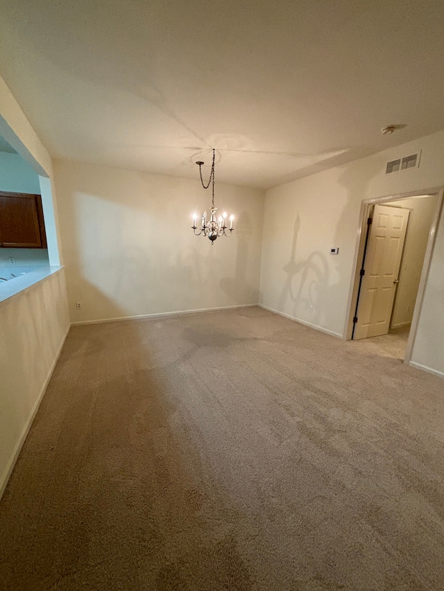 interior space with a chandelier, baseboards, visible vents, and light colored carpet