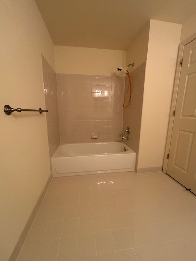 bathroom featuring bathing tub / shower combination, baseboards, and tile patterned floors