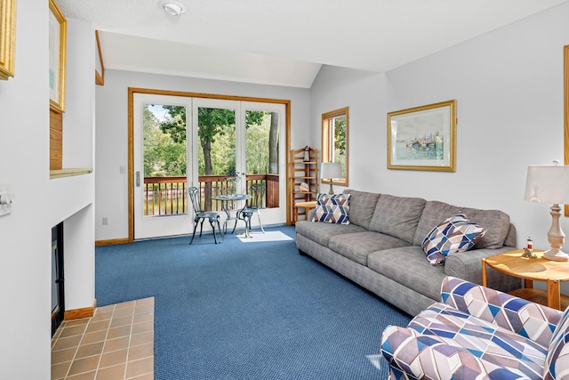 living room featuring carpet floors and vaulted ceiling