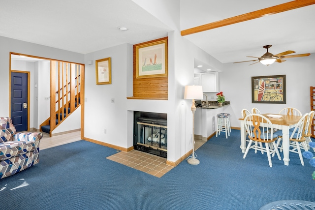 carpeted living room featuring ceiling fan