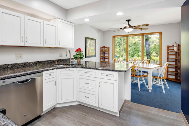 kitchen with stainless steel dishwasher, ceiling fan, white cabinetry, and sink