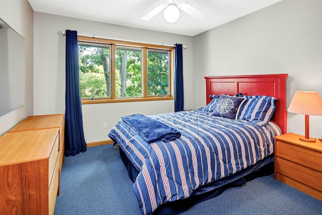 bedroom featuring ceiling fan and carpet