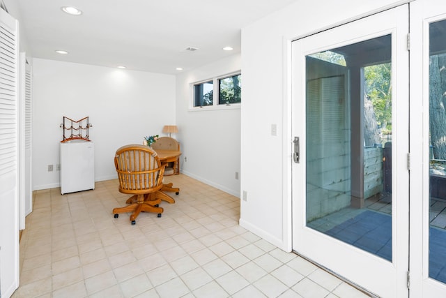 office area featuring plenty of natural light and light tile patterned flooring