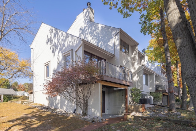 rear view of property featuring a balcony