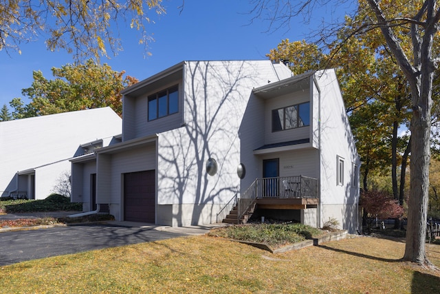 view of front facade with a garage and a front lawn