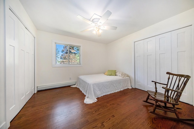 bedroom with a baseboard heating unit, a closet, and wood finished floors