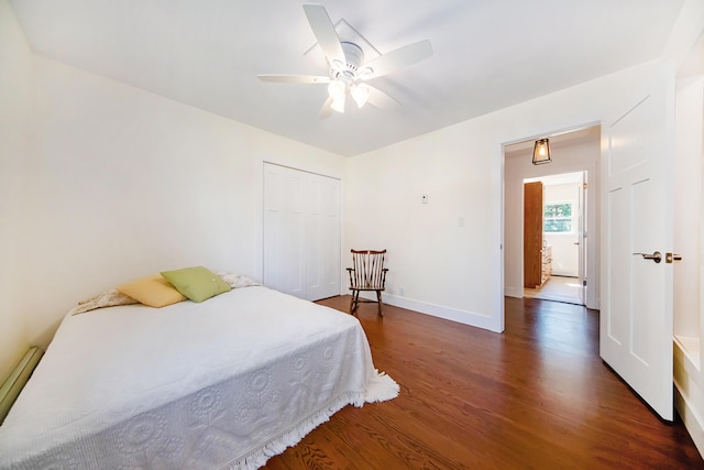 bedroom featuring a closet, a ceiling fan, baseboards, and wood finished floors