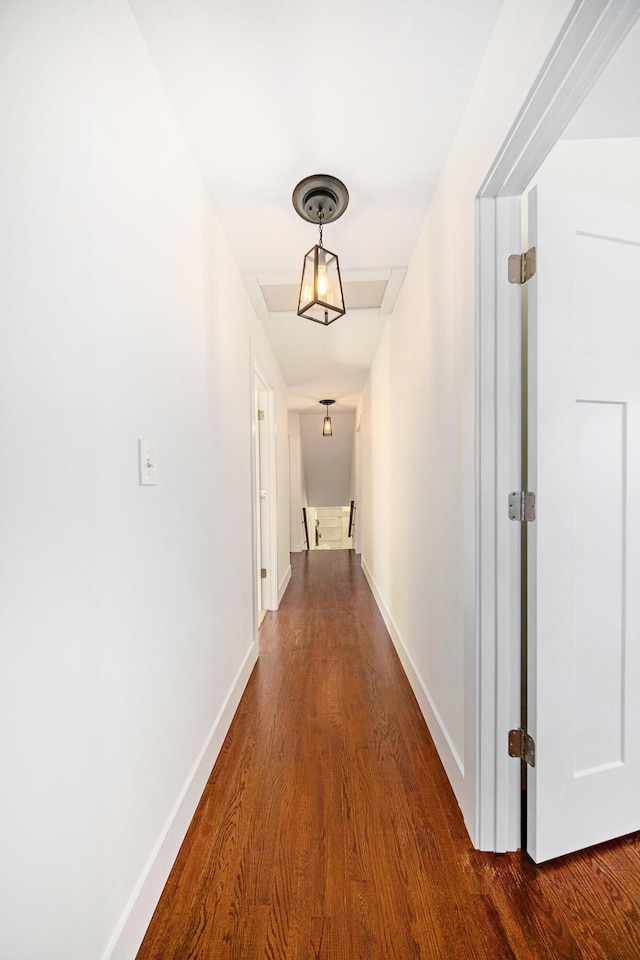 hall featuring baseboards and dark wood-style floors