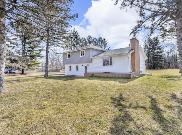 rear view of house with a lawn and a chimney